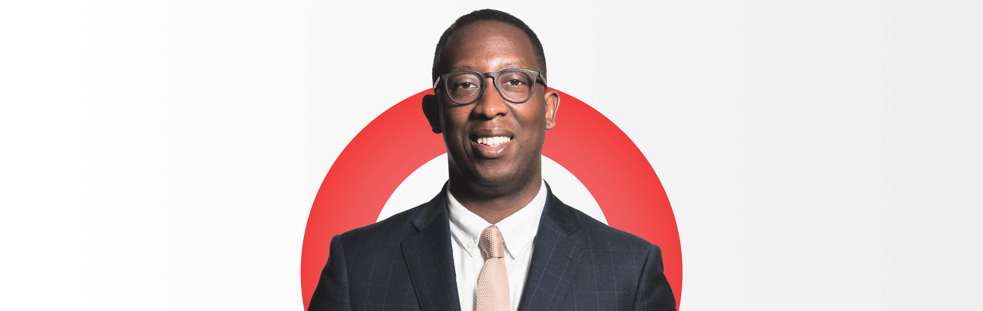 A corporate headshot of Lindsey Stewart, Director of Stewardship Research and Policy at Morningstar Sustainalytics wearing a suit, glasses, and cream tie